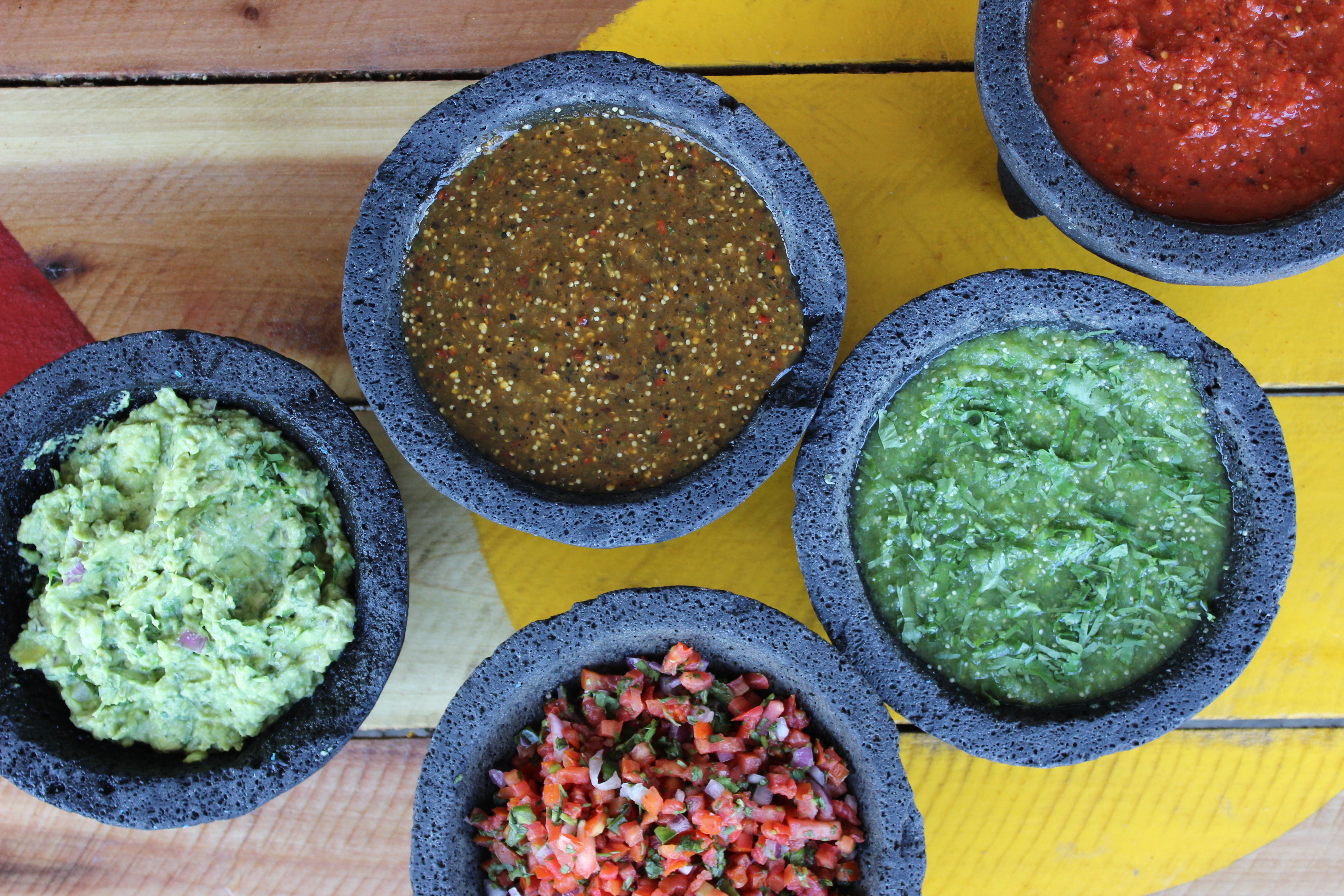 Bowls of sauces and dips for the nachos and tacos